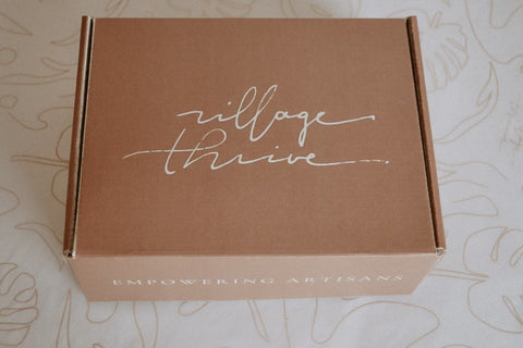 A view of the custom Village Thrive terracotta with white text box from above, showing the village thrive logo
