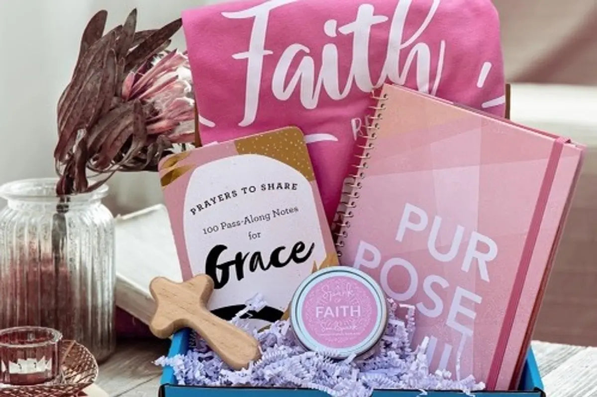 Box of products related to faith and grace with wooden cross