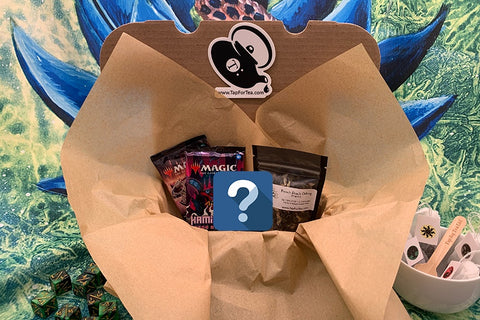 Tap For Tea Starter Box. Contains two sealed Magic: the Gathering packs, one premium tea packet, and a surprise!