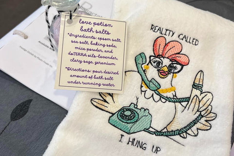 Handmade love potion bottle with instructions for use in your bath. An embroidered towel with a chicken "Reality called, I hung up"