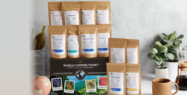 Bean Box's World Coffee Tour gift box with a stack of Bean Box coffee bags from independent roasters