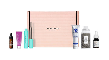 BeautyFIX by Dermstore pink subscription box with skincare, mascara, and hair products lined up on each side