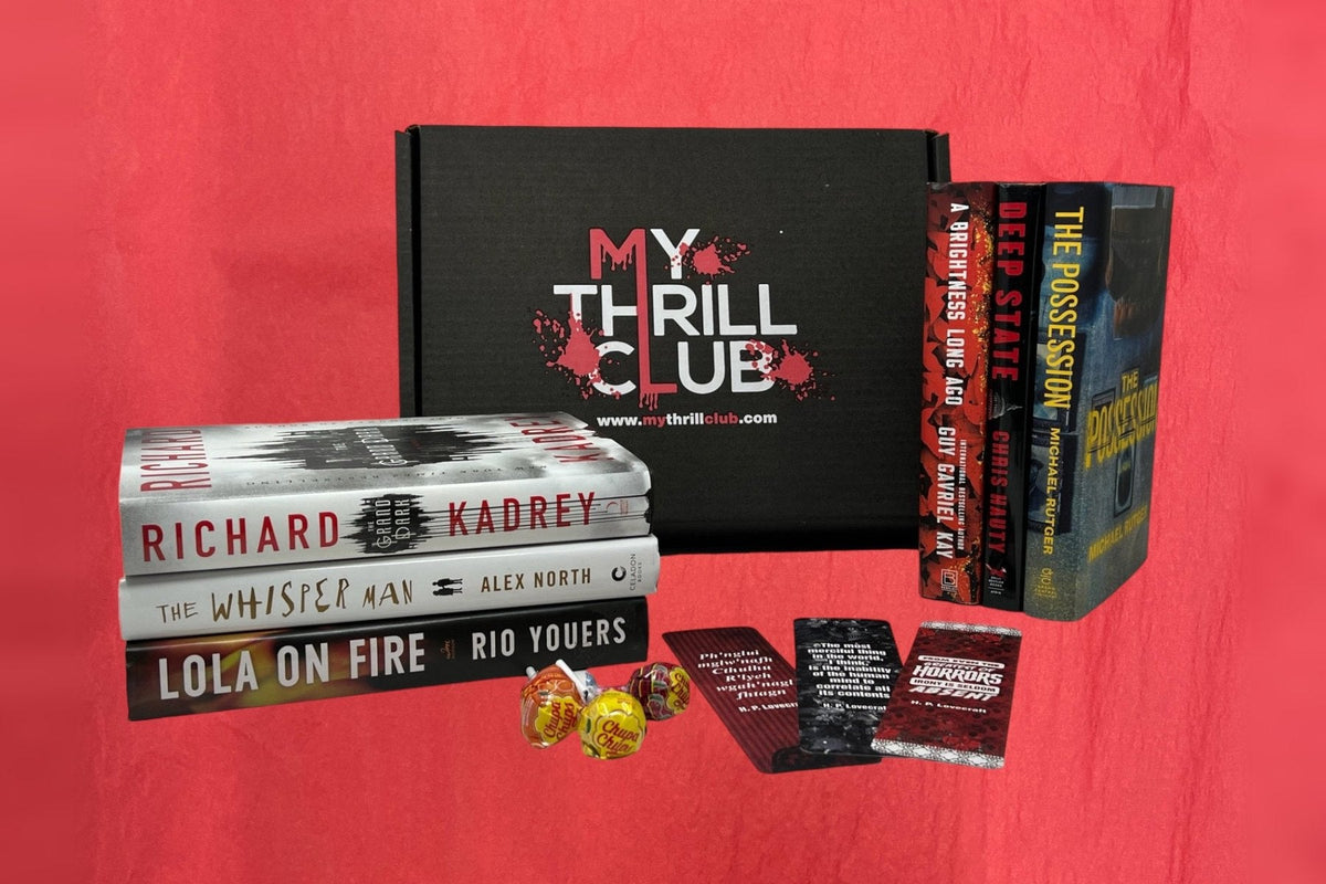 My Thrill Club’s black box with its red-splattered logo, surrounded by hardcovers including The Whisper Man, Lola on Fire, and Deep State, plus H. P. Lovecraft bookmarks and lollipops on a red backdrop.