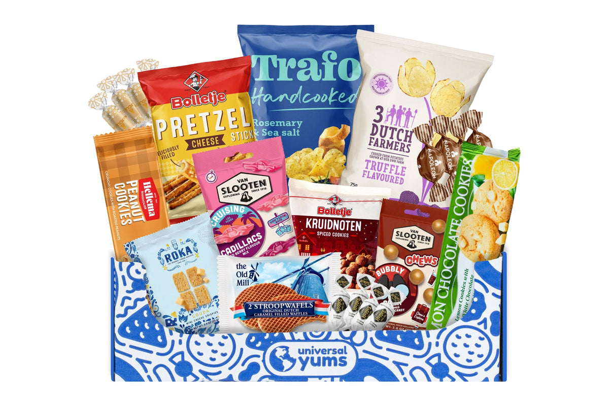 A Universal Yums box printed with the Universal Yums logo, filled with Dutch snacks including stroopwafels, Bolletje pretzel sticks, and Trafo potato chips