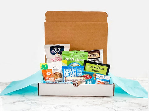gluten free snacks in box such as lesser evil, pretzels, made good, almonds