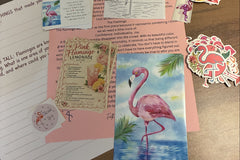All pieces of the November happy mail arranged in a flat lay. The Stand Tall journal page, stickers, print, collector card and recipe card