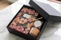 Out bloom floral journal box featuring Bruno Visconti floral journal and gold pen, Monet Garden Soy was candle and prosecco gummy bears 