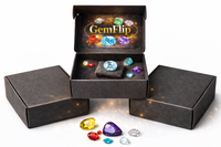 GemFlip gemstone box opened on a white background, showing a black premium box with branded logo and a selection of faceted natural gemstone