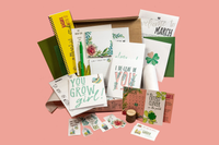 Plant-themed stationery flat lay with “You Grow Girl” and “I Be-Leaf in You” designs from My Paper Box March box, featuring cactus art.