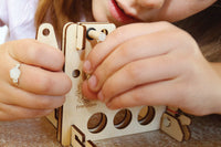 A child building BrainStorm's Catapult STEM Kit.