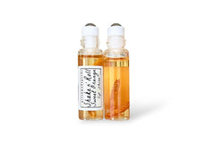 Orange Shake and Roll Lip Shine serum by Greenmade goods in a clear roller ball glass container against a white background.