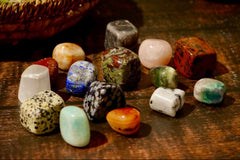 pic of tumbled stones including: dalmatian jasper, amazonite, lapis lazuli, sun stone, carnelian, dragon bloodstone