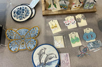 This picture is mug rugs and earrings all embroidered with love. Pictured are flowers, butterfly and dolphin rugs. Easter themed earrings as