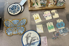 This picture is mug rugs and earrings all embroidered with love. Pictured are flowers, butterfly and dolphin rugs. Easter themed earrings as