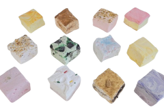 Top‑down grid of 12 artisan marshmallows with colorful toppings. Assorted gourmet marshmallow squares in seasonal flavors