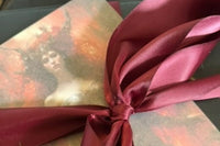 Busy Witch Box with burgundy ribbon and an altar card, showcasing the Witchcraft Subscription Box for Sabbat rituals