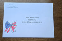 White envelope with printed sample U.S. mailing address and a red, white and blue patriotic bow with stars and stripes.