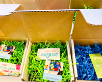 Multiple Fidget Toy Boxes with inspirational cards and toys. Monthly Mystery boxes lined up in rows. 