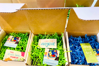 Multiple Fidget Toy Boxes with inspirational cards and toys. Monthly Mystery boxes lined up in rows. 