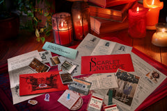 Scarlet Envelope Secret Society subscription box featuring a red envelope and mystery-themed items for an escape room experience