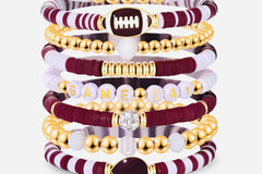 Game Day 8-piece stackable friendship bracelet set in maroon, white, and gold CZ beads with football, helmet, and GAME DAY letter charms, sh