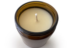 Top view of an unlit 9oz Burlap Bag soy candle showing the single cotton wick centered in smooth cream soy wax