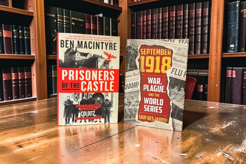 Two hardcover history books, Prisoners of the Castle and September 1918, sit on a wooden library table.