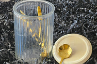 Elegant glass container with bamboo lid—3.25" wide x 5" tall. Perfect for storing coffee, tea, or small kitchen essentials.