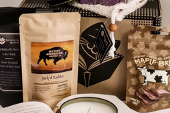 Introverts Retreat box showing coffee, maple brittle and bath salt soaks next to the actual box in the back.