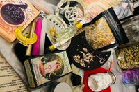 An assortment of items from the Busy Witch Box, a witchcraft subscription box featuring ritual tools and supplies