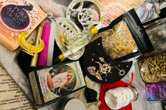 An assortment of items from the Busy Witch Box, a witchcraft subscription box featuring ritual tools and supplies