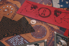Scarlet Envelope Secret Society subscription box featuring intricate puzzles and mystery-themed cards for an engaging escape room experience