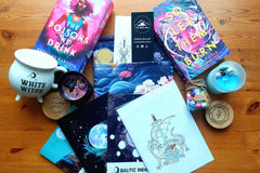 Shows a selection of the gift products we do including sprayed edge book , candle , mug , art print , the jar and notebook and book sleeve