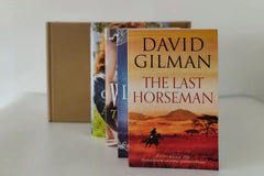 Brown subscription box filled with four fantasy novels, featuring magical worlds and adventurous plots for fans of imaginative storytelling