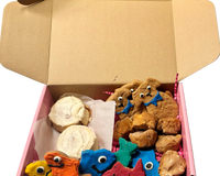 Assorted handmade organic bakery-style dog treats including decorated cookies and donuts