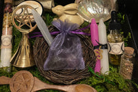Contents of the Busy Witch Box include a pentacle altar bell, wooden hare, ritual bath blend, and candles for Sabbat rituals
