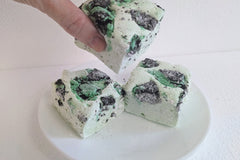 Close-up of mint cookie‑crumble marshmallows on a white plate. This is a gluten-free option and yummy.
