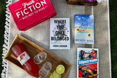 books on picnic blanket with box