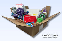 An I Woof You Discovery Kit includes a tug toy, a food puzzle, treats, a paw painting kit, and a click stick.