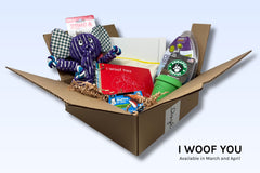 An I Woof You Discovery Kit includes a tug toy, a food puzzle, treats, a paw painting kit, and a click stick.