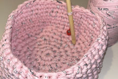 A close up of the basket you can make with the T-shirt yarn and bamboo hook. The stitch marker is inside too.