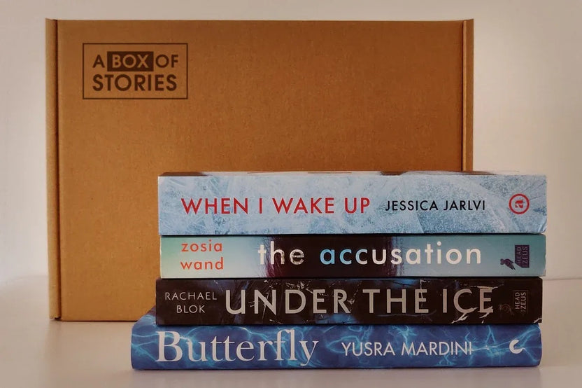 Brown box filled with fiction books, showcasing a variety of gripping titles and intriguing covers, perfect for mystery lovers.