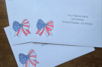 Three white envelopes with printed sample U.S. mailing addresses and red, white and blue patriotic bow designs featuring stars and stripes.