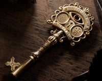 Very high quality close up photo of a detailed old key that is part of a mystery and escape game box.