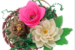 A flower themed bird toy. Made up of a variety of textures, including papers, sola, palm, and mahogany. Mostly naturally colored 
