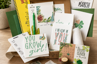 Plant-themed stationery flat lay with “You Grow Girl” and “I Be-Leaf in You” designs from My Paper Box March box, featuring cactus art.
