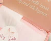 A collection of pink, pretty objects laid out, promoting happiness, self-love, and a touch of elegance.