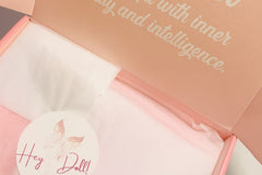 A collection of pink, pretty objects laid out, promoting happiness, self-love, and a touch of elegance.