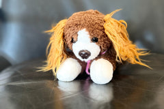 A head shot of the snorri stuffed animal. You can see her light brown ears, brown and white face, brown eyes and nose. 