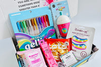 Colorful items in the TWEEN WISHBOX subscription box include gel pens, a notebook, and fun accessories for tween girls